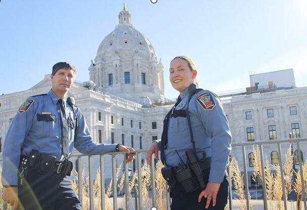 two capitol security officer smiling in front of Capitol