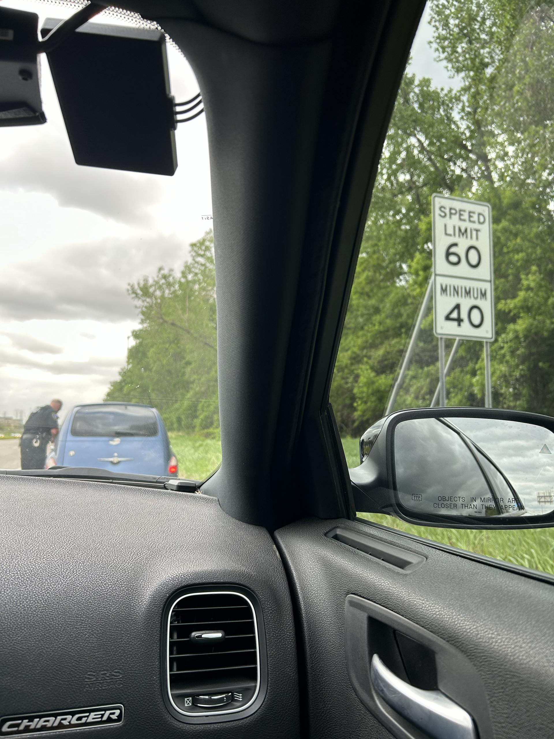 Law enforcement officer pulling over a driver for a traffic safety violation